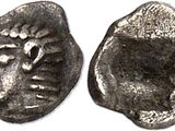 une pièce d'argent sur laquelle figure un visage au recto et un autre au verso