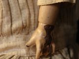a close up of a doll with a glove on it ' s arm