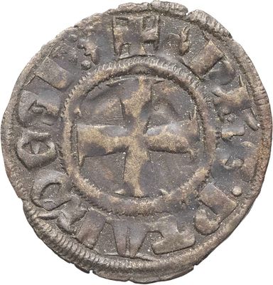 une vieille pièce d'argent sur laquelle figure une croix au recto