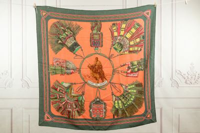 an orange and green scarf hanging on the wall