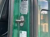 a close up of the door of a green vehicle