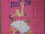 a pink poster with a picture of a woman doing a flip on a bed