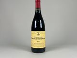 a bottle of red wine sitting on top of a table