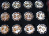 nine different coins in a black box on a table