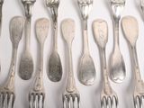 a lot of silver spoons and forks on the table
