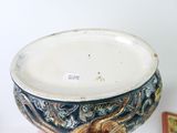 someone is holding a blue and white bowl with a gold dragon on it