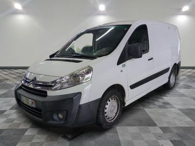 the white van is parked on a checkered floor in a room