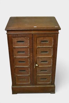 a small wooden cabinet with drawers and a door