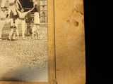 an old photo of a baseball player holding a bat