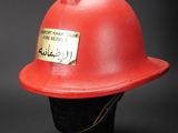 a red fireman ' s hat on a black mannequin head