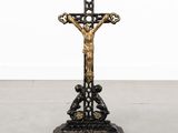a black and gold crucif with a cross on top of it