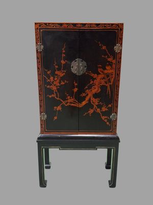 a black cabinet with a red and black design on it