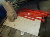 a pile of orange poles sitting on the floor