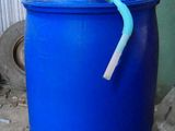 a blue barrel with a pipe sticking out of it