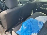 a car that has a bag in the back seat of it