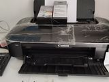 an image of a printer sitting on a desk with a keyboard