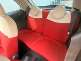 two seats in the back of a car that are red and white