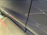 a close up of a blue car with a broken door handle