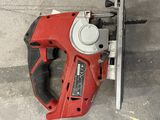 an image of a red corded drill on a concrete floor