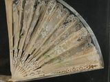 a glass display case with a fan inside of it