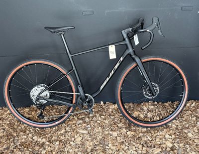 un vélo posé contre un mur, par terre