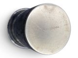 a close up of a metal knob on a white surface
