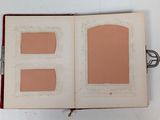 an open book with two pictures on it on a table