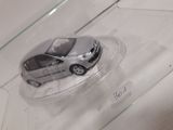 a small toy car in a clear container on a table