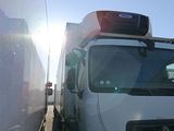 a white truck that is parked next to a wall