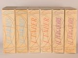 four boxes of cigarettes are lined up in a row on a white surface