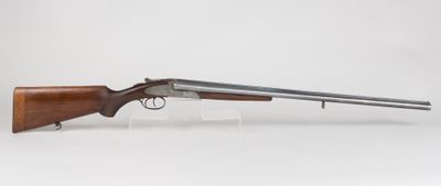 a rifle with a wooden barrel and a wooden handle