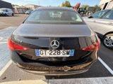 a black car parked in a parking lot with other cars