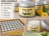 some jars of creams are sitting on a table next to a box of flowers