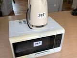 a microwave sitting on top of a table with a toaster on top of it