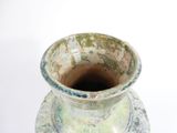 a vase that is sitting on a white surface