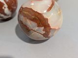 three marble balls that are sitting on a table