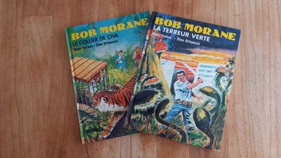 two books that are sitting on a wooden table