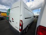 the rear end of a white van parked in a parking lot