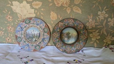two plates that are sitting on a bed