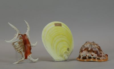 three figurines of different shapes and sizes on a table
