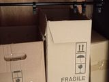 a shelf with boxes and an iron on it