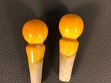 two yellow knobs sitting on top of a black surface