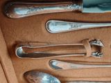 a lot of silver spoons and spoon spoons in a box