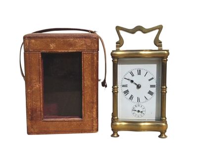 a small clock that is next to a small box
