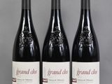 three bottles of red wine sitting on a table next to each other