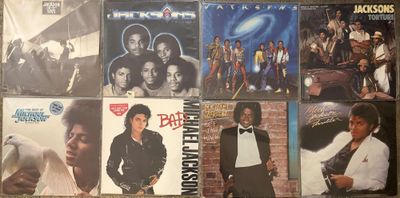 a lot of different album covers on the wall