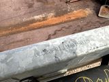 a close up of a metal bench with writing on it