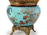 a blue vase with flowers on it and a gold crown on top