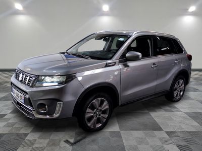 the silver suv is parked on a checkered floor in a garage
