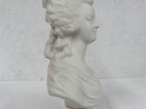 a white busturine of a woman with braids on her hair